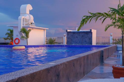 a swimming pool in front of a building at Kandi Heaven in White Tower in Angeles