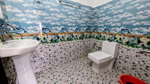 a bathroom with a toilet and a sink at Vista Valley View homestay in Dirang Dzong