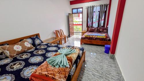 a living room with a bed and a couch at Vista Valley View homestay in Dirang Dzong