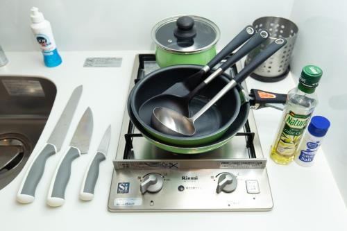 a pot on top of a stove with utensils at #17 -シーフォルム京急蒲田- Entire Unit in Tokyo