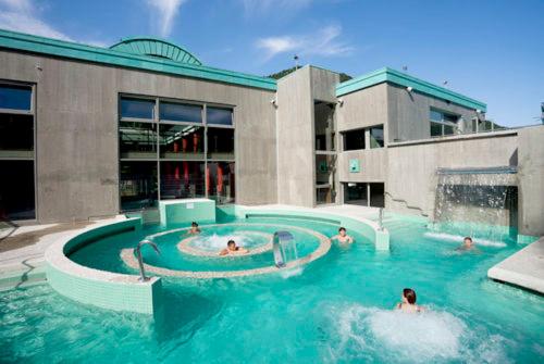 a group of people in a swimming pool in a building at Apartment Coecilia in Ax-les-Thermes