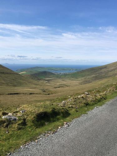 a road on the side of a hill with a view at Cois Chnoic in Dingle