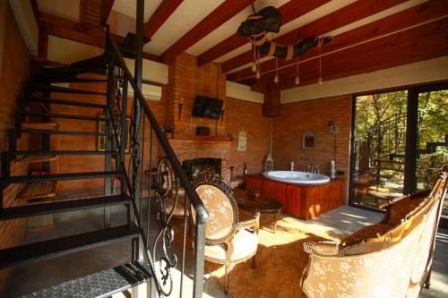 a room with a staircase and a bath tub at Villa Vejini cabin in Mamkoda