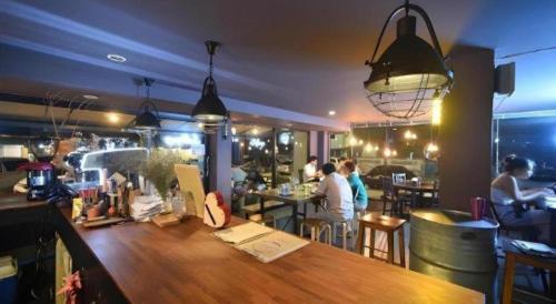 a bar with people sitting at tables in a restaurant at CHANTHABURI CENTER in Chanthaburi