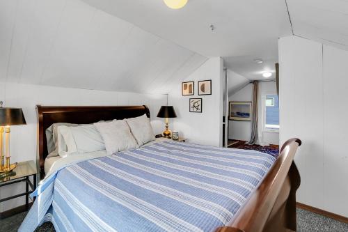 a bedroom with a bed with a blue and white striped blanket at Northgate Station in Seattle