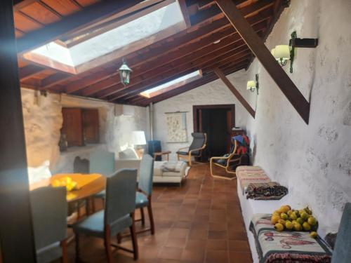 a living room with a table and chairs and a dining room at Große Finca 19Jh, Pool, Terrasse, nahe Santa Cruz in Santa Cruz de la Palma