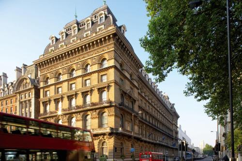 a building with a double decker bus in front of it at The Clermont London, Victoria in London