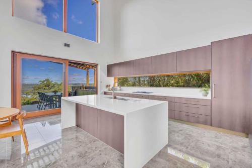 a kitchen with a large white counter and a table at The Haven Montville in Montville
