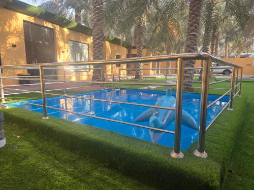 a swimming pool with an inflatablelatablehett at منتجع حبايبي in Al Mubarraz