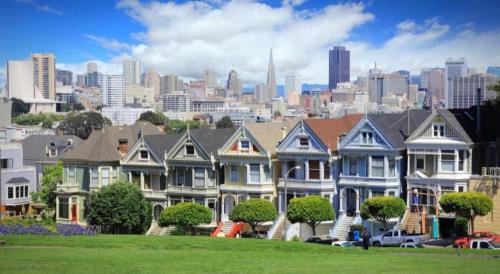 una fila di case con una città sullo sfondo di The Annex - Hayes Valley a San Francisco
