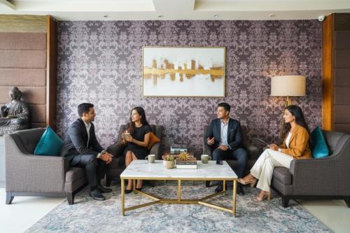 a group of people sitting in a living room at FabHotel VJR Electronic City in Bengaluru