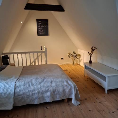 a bedroom with a bed and a chalkboard on the wall at oasen stenholt in Sønder Stenderup