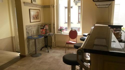 a room with two chairs and a table and a window at Hotel Queen Mary in Brussels