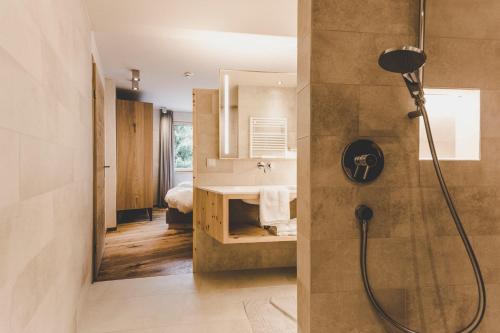a bathroom with a shower and a sink at Arabella Retreat & Spa in Nauders