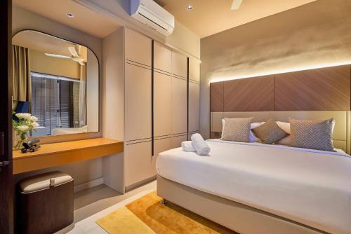 a bedroom with a large white bed and a mirror at Antara Genting by COBNB - Antara AIR Genting Highlands in Genting Highlands