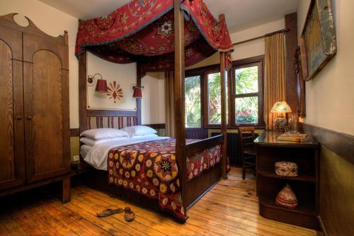 a bedroom with a four poster bed with a canopy at Hotel Empress Zoe in Istanbul