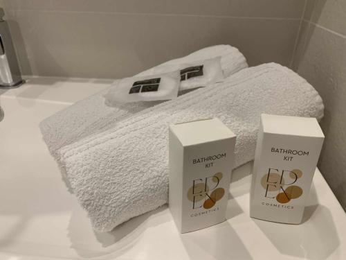 a bathroom with two boxes of complimentary towels on a counter at Studio à 2 minutes de la plage in La Grande-Motte