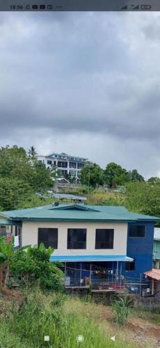 a blue and white house with a blue roof at JNSi Appartments in Honiara