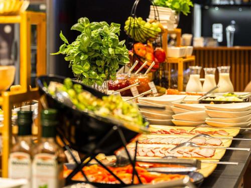 オポーレにあるメルキュール オポールのテーブルの上に料理が並んだビュッフェ