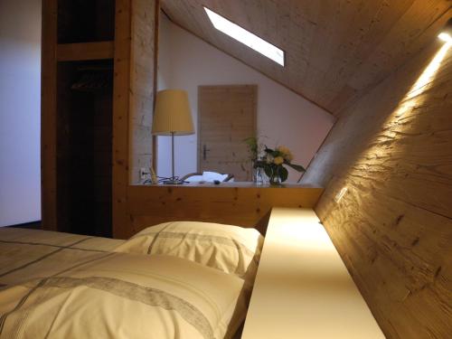 a bedroom with a bed with a light on it at L'Ours in Bischwiller