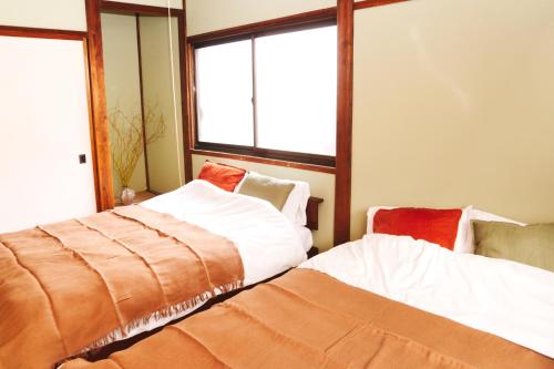 Ένα ή περισσότερα κρεβάτια σε δωμάτιο στο Cozy Fukui