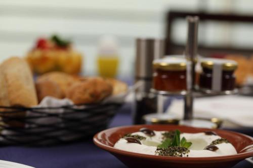 a plate of food on a table with bread at Warwick Palm Beach Hotel in Beirut