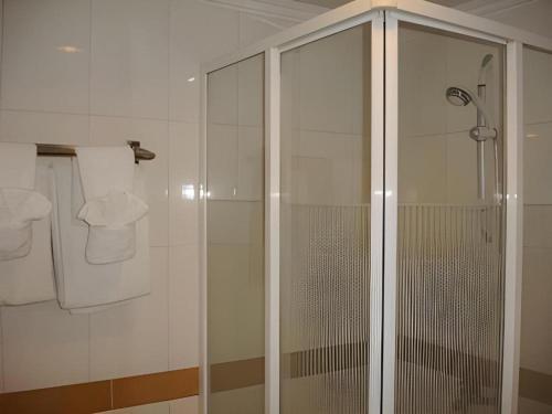 a shower with a glass door in a bathroom at Casa Boutique Hotel in Phnom Penh