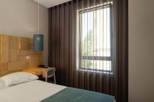 Ένα ή περισσότερα κρεβάτια σε δωμάτιο στο Boavista Guest House