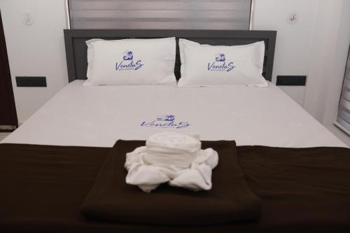 a bed with a pile of towels on it at Venetus Beach Residence in Varkala