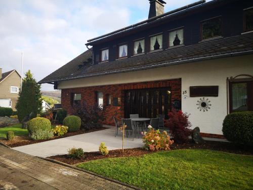 a house with a table in front of it at Pension Sonnenblick in Winterberg