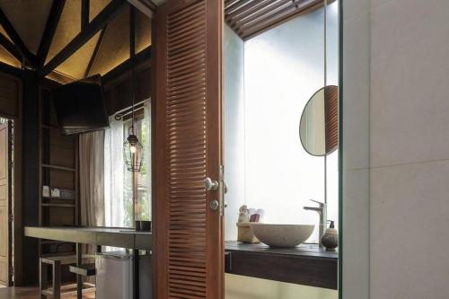 a bathroom with a sink and a bowl on a counter at The Spa Resorts - Lamai Village in Ban Thung