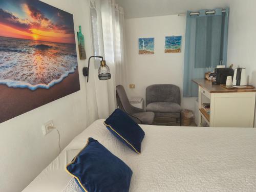 a bedroom with a bed with blue pillows on it at בית המזל Fortune House in Bet Sheʼan