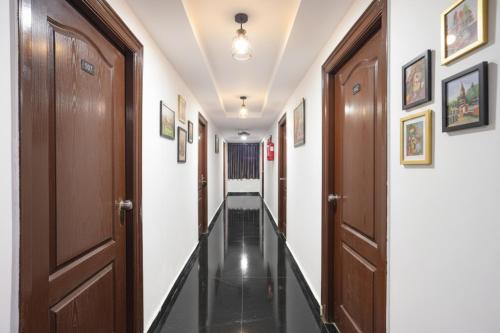 a corridor with wooden doors and white walls at Via Dream Nest in Hyderabad