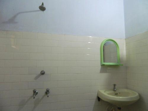 a bathroom with a sink and a mirror at David Homes in Cochin