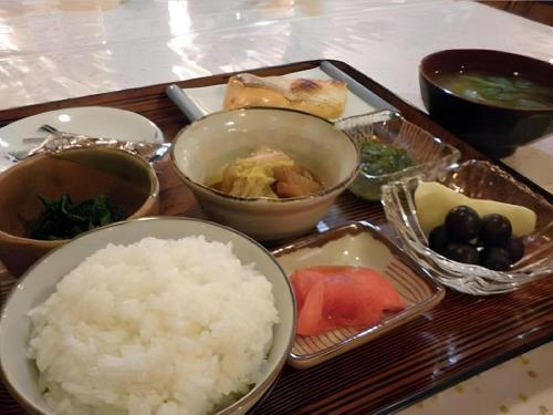 a tray of food with rice and other foods at Date Business Hotel Castle in Date