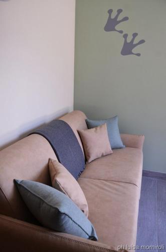 a couch with pillows on it in a room at Residence Orma in Alagna Valsesia