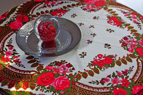 a plate with a bowl of red sauce on a table at B&B La Terre Brûlée in Aigues-Mortes