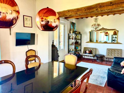 a kitchen and living room with a table and chairs at Spectacular Views from Private Apartment in a Local Umbrian Village in Gioiella