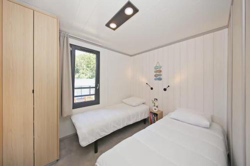 En eller flere senge i et værelse på Le Tranquillou