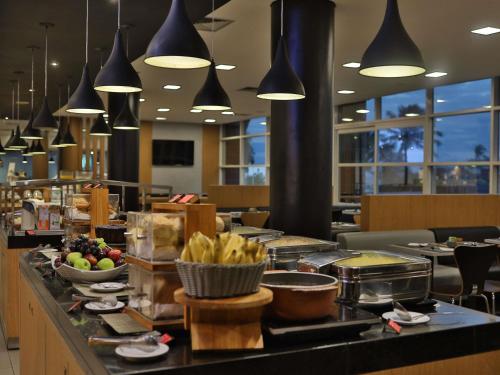 a buffet line in a restaurant with food on it at Ibis Salvador Rio Vermelho in Salvador