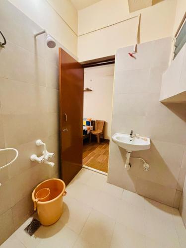 a small bathroom with a sink and a toilet at Citynest Residency in Pondicherry