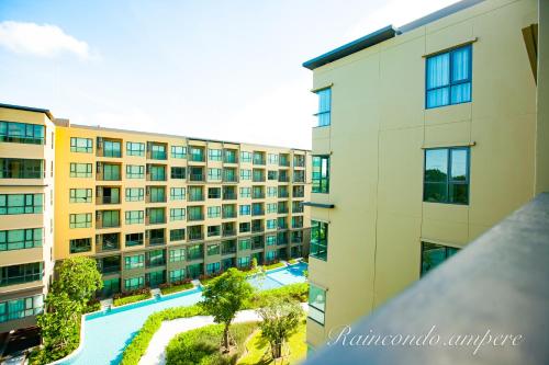 an aerial view of an apartment building with a swimming pool at Raincondo Ampere in Cha Am