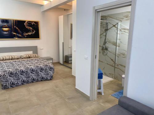 a bedroom with a bed and a walk in shower at La Tavernetta delle Terme Euganee in Montegrotto Terme