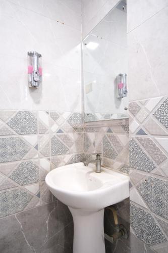 a bathroom with a toilet and a sink at Shiva Guest House in Guwahati