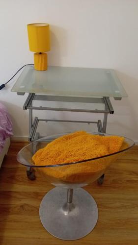a glass table with a bowl of food on a table at Double Room Near EU, City Centre in Brussels