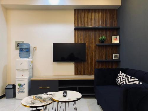 a living room with a couch and a tv at Luxury, Modern & Central Apartment Islamabad, with Gym, Near Motorway & Airport in Islamabad
