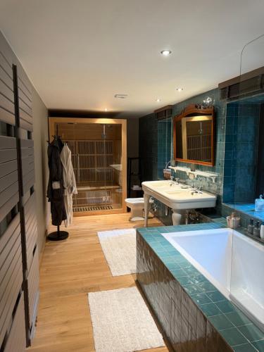 a large bathroom with a tub and a sink at gite-abicyclette in Yvoir