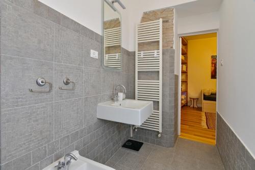 a bathroom with a sink and a mirror at Residenza La Donzella - Appartamento bianco in Campobasso
