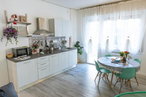 a kitchen with a table and chairs and a dining room at ANGELA GUEST HOUSE in centro storico in Conegliano