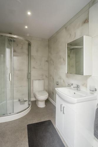 a bathroom with a toilet and a sink and a shower at Modern Studio Bolton ,Free Parking, Fast WiFi, Ideal for Contractors & Long Stays in Bolton